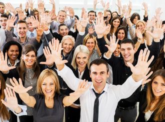 People waving their hands in the air and smiling